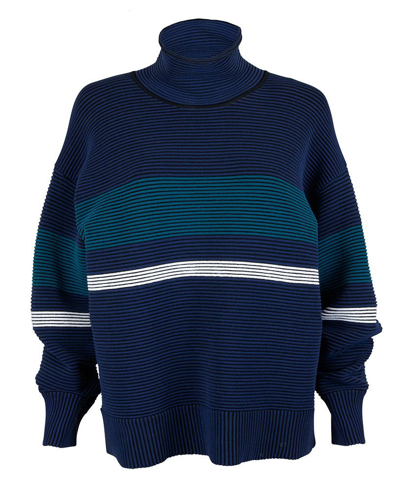 Female model wears the Nagnata Retro Rib Sweater in navy and teal blue