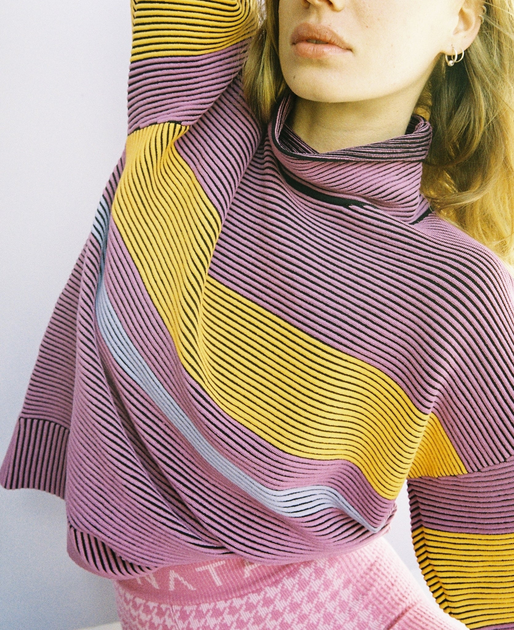 Female model wears the Nagnata Retro Rib Sweater in purple haze and tangerine