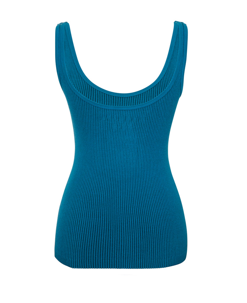 Female model wears the Nagnata Avika Tank in black and teal with the Yoni Short in Navy