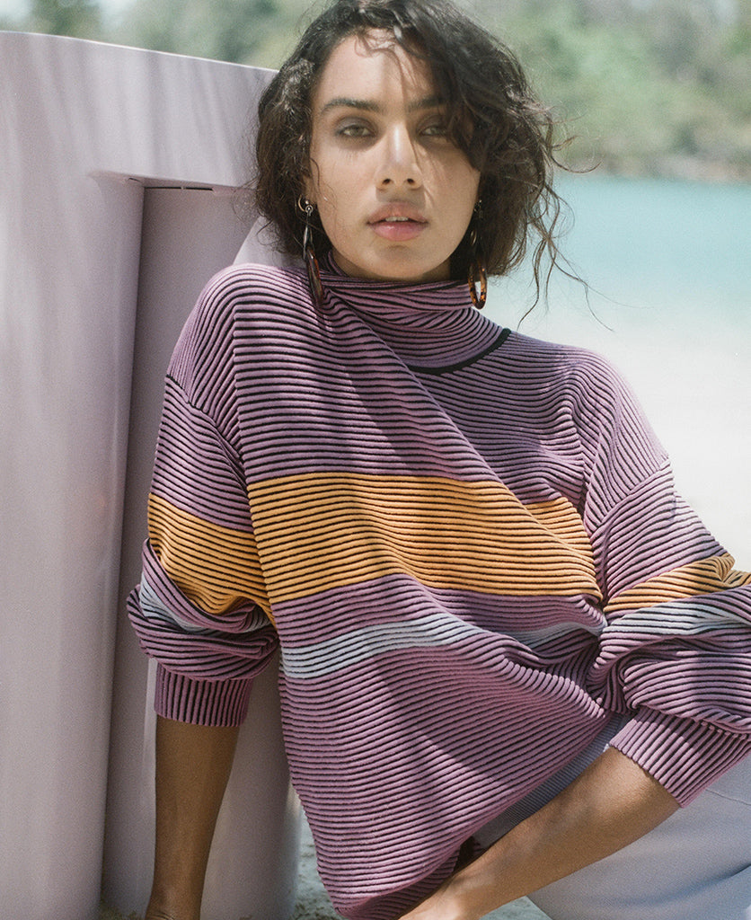 Female model wears the Nagnata Retro Rib Sweater in purple haze and tangerine
