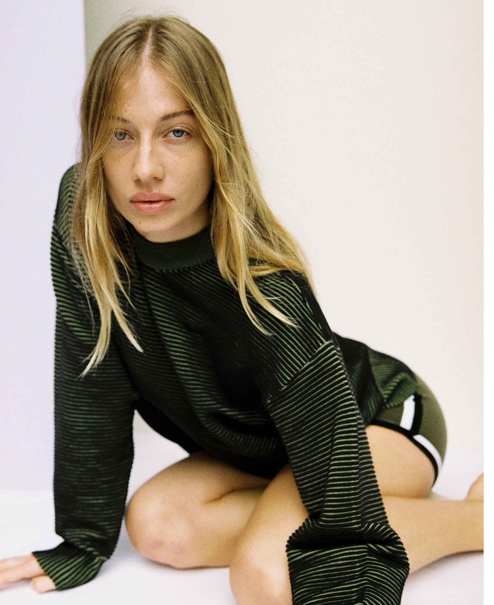 Female model wears the Nagnata Sonny Crew Neck Sweater in black and khaki