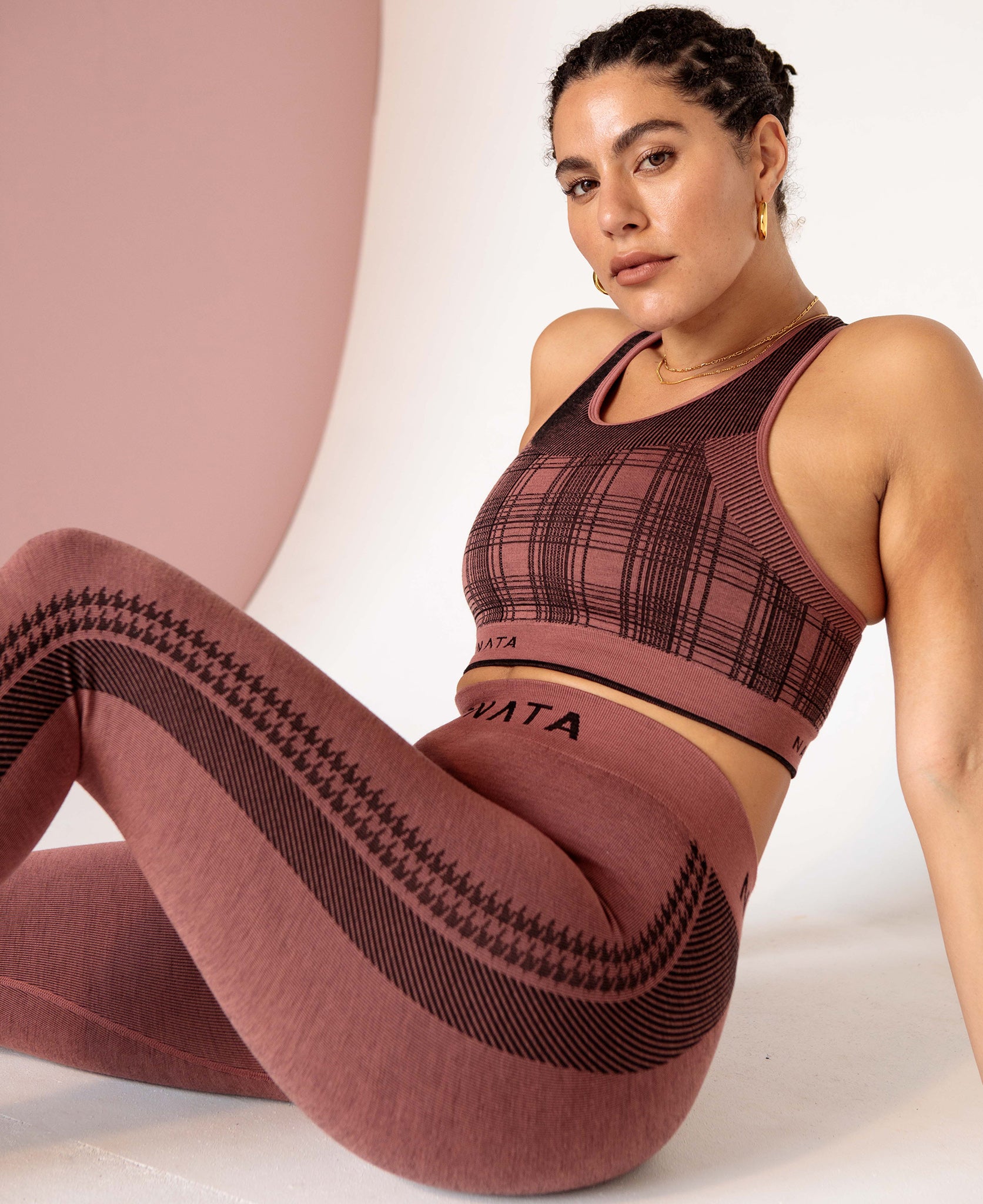 Female model wears the Nagnata Check-Back Racer Crop top in blush and black