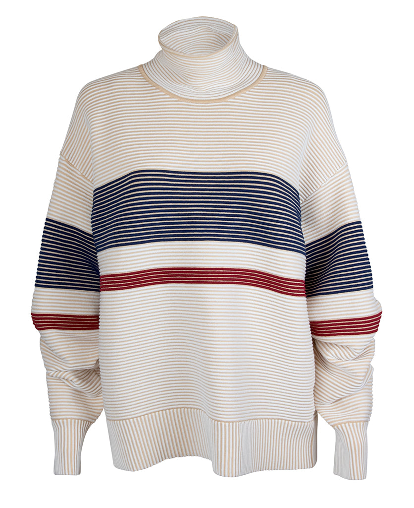 Female model wears the Nagnata Retro Rib Sweater in cream and navy