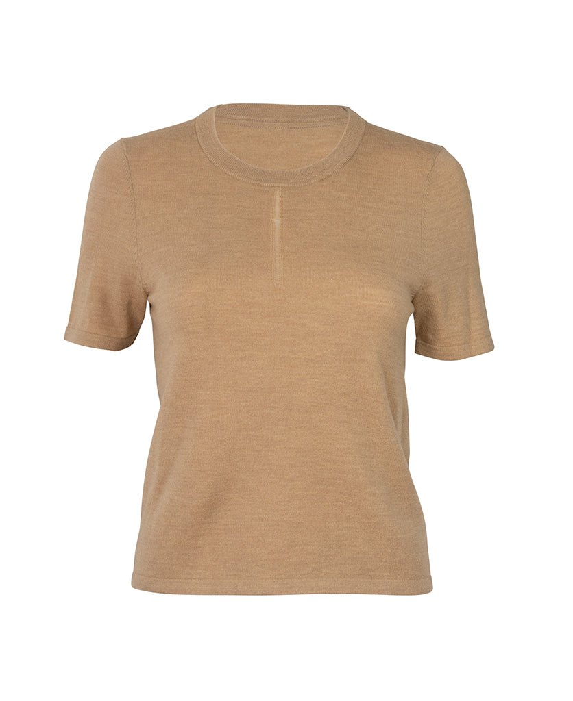 Female model wears the Nagnata Merino Trash Tee in sandstone