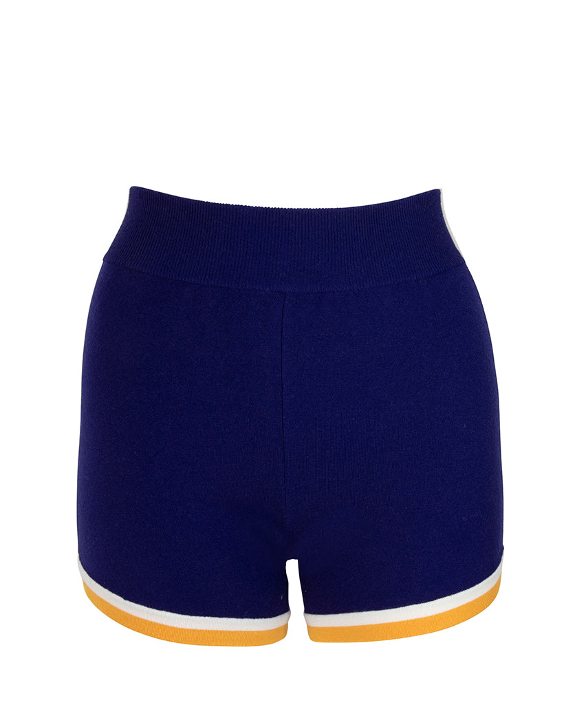 Female model wears the Nagnata Retro Short in blue, cream and saffron