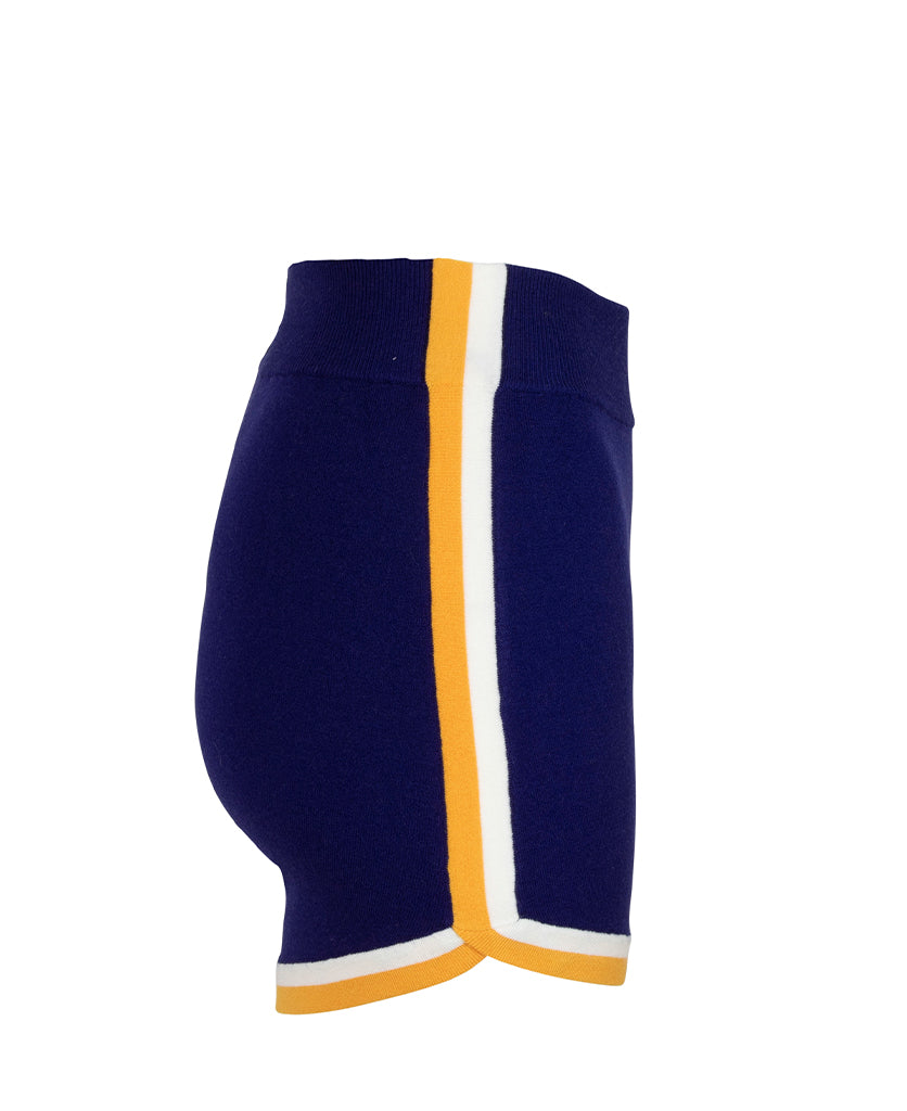 Female model wears the Nagnata Retro Short in blue, cream and saffron