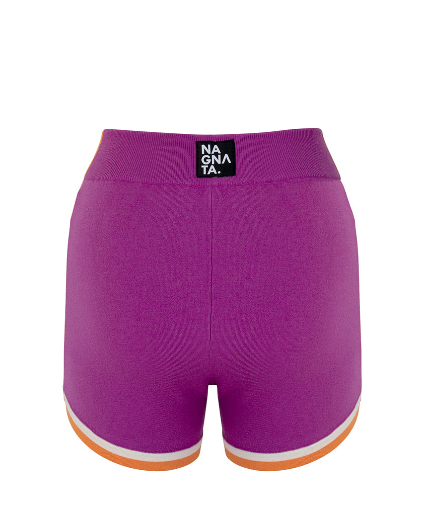 Female model wears the Nagnata Retro Short in purple haze, cream and orange