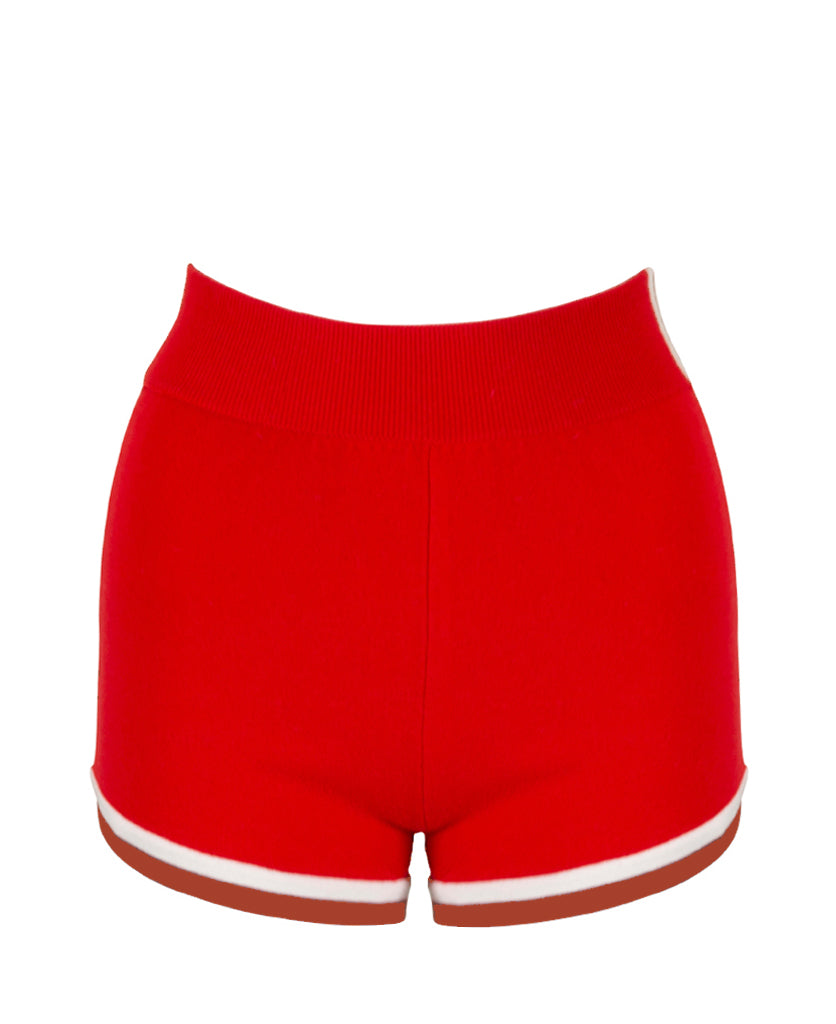 Female model wears the Nagnata Retro Short in red, cream and rust
