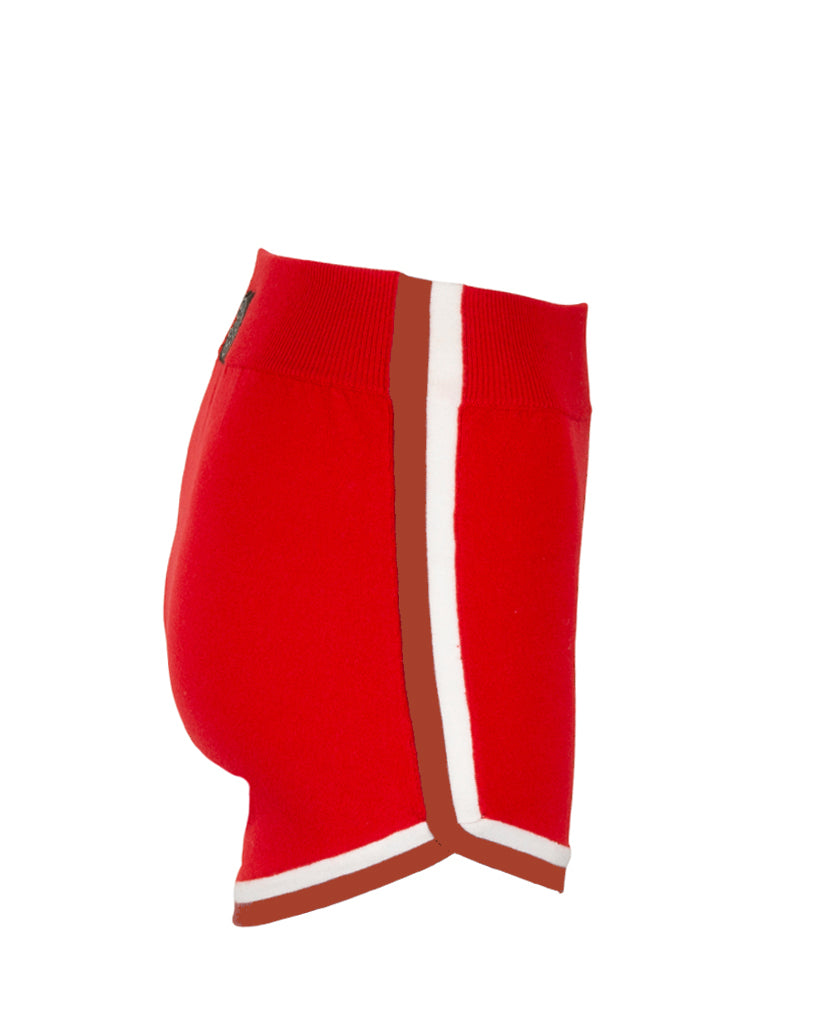 Female model wears the Nagnata Retro Short in red, cream and rust
