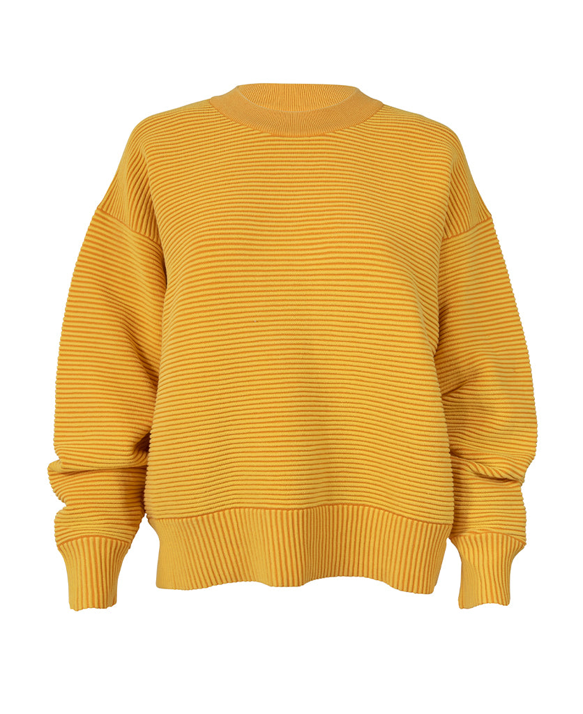 Female model wears the Nagnata Sonny Crew Neck Sweater in lemon and tangerine