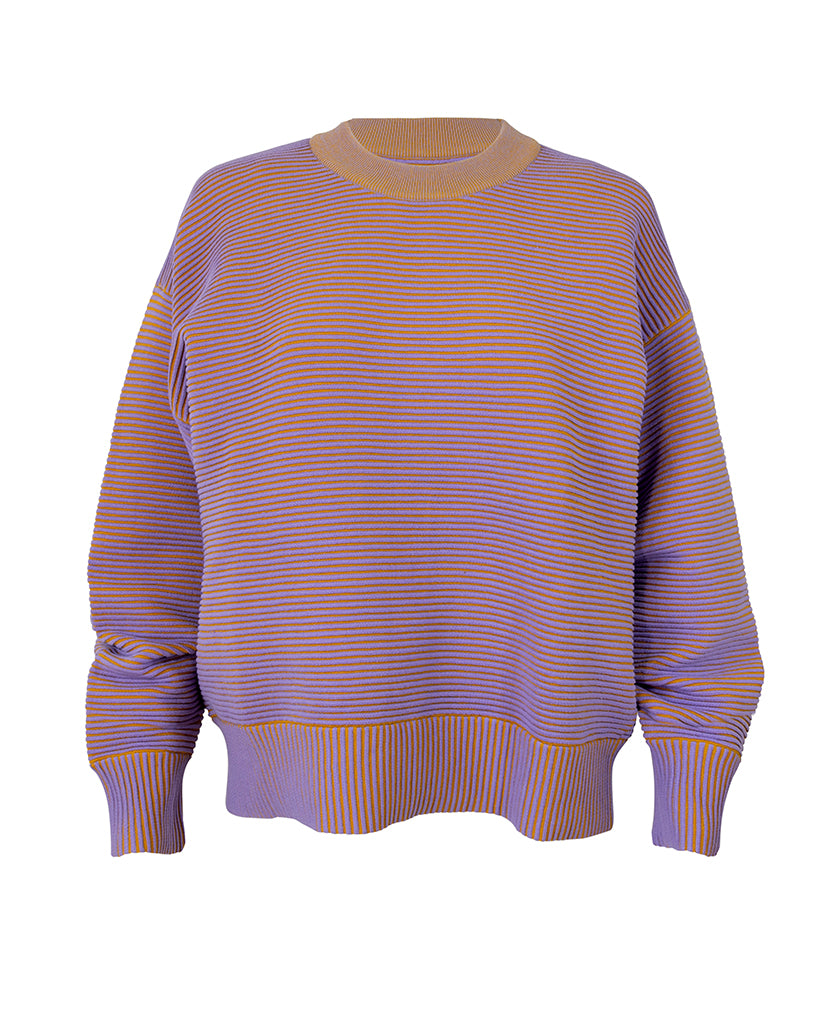 Female model wears the Nagnata Sonny Crew Neck Sweater in lilac and turmeric
