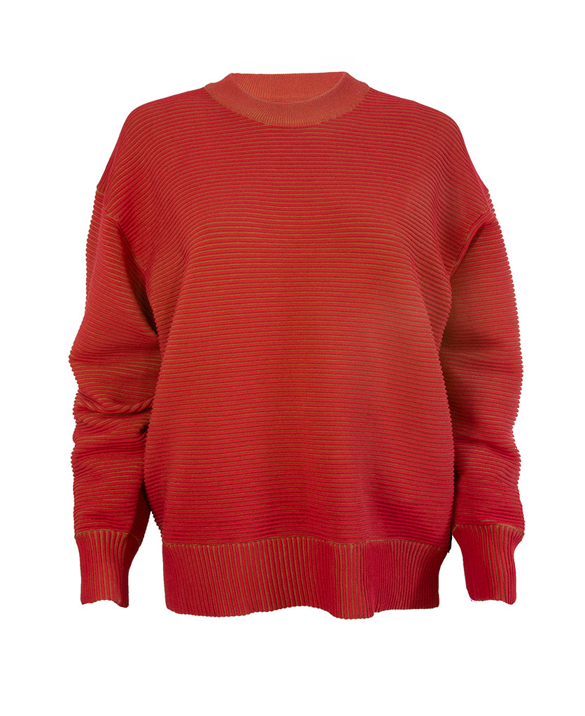 Female model wears the Nagnata Sonny Crew Neck Sweater in red and bronze