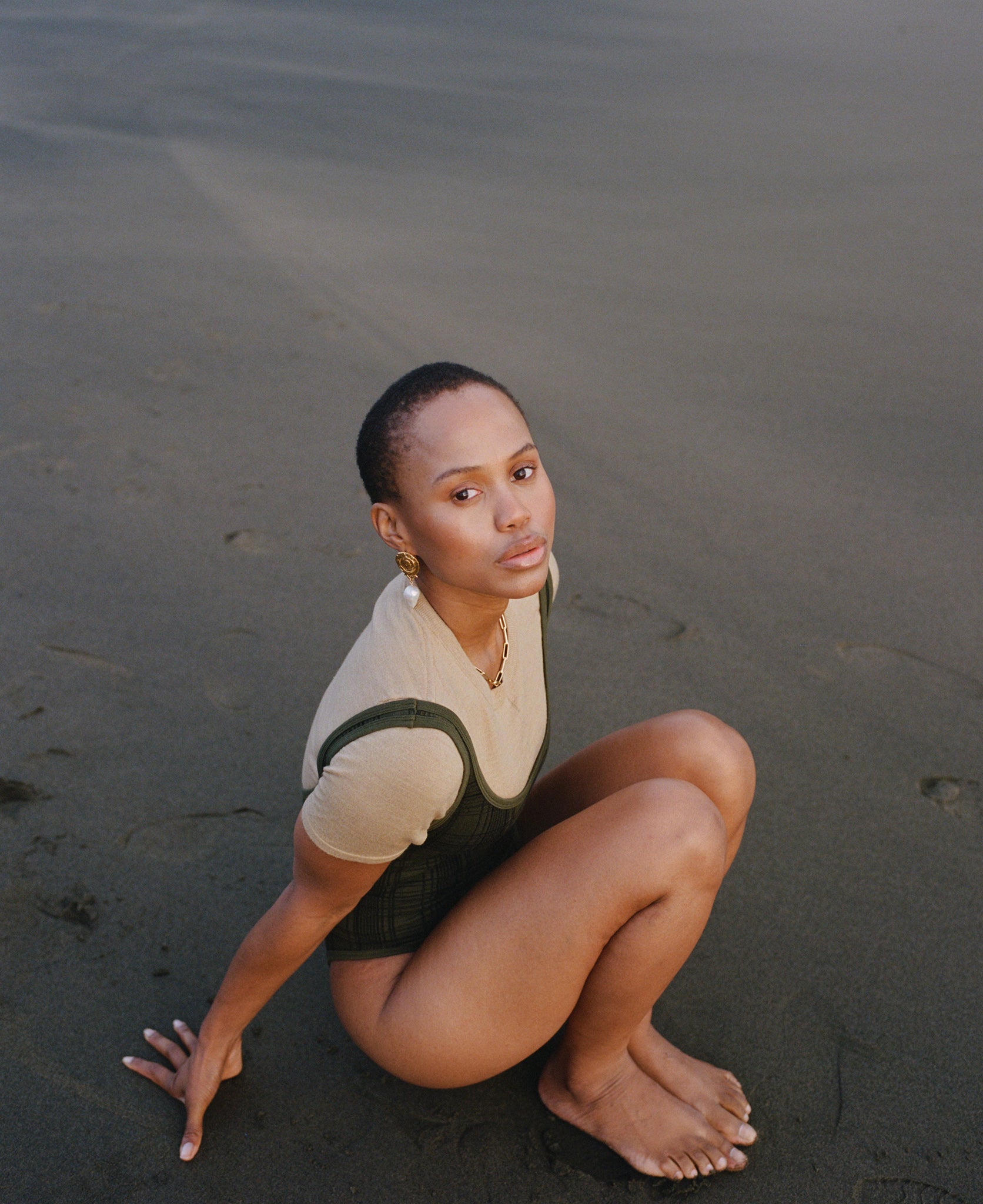 Female model wears the Nagnata Merino Trash Tee in sandstone