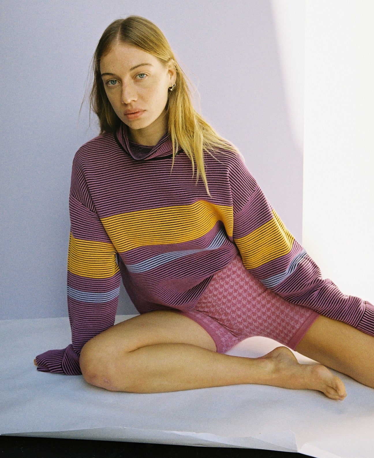 Female model wears the Nagnata Retro Rib Sweater in purple haze and tangerine