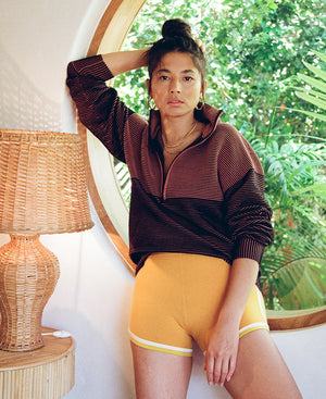 Female model wears the Nagnata Retro Short in saffron and lemon