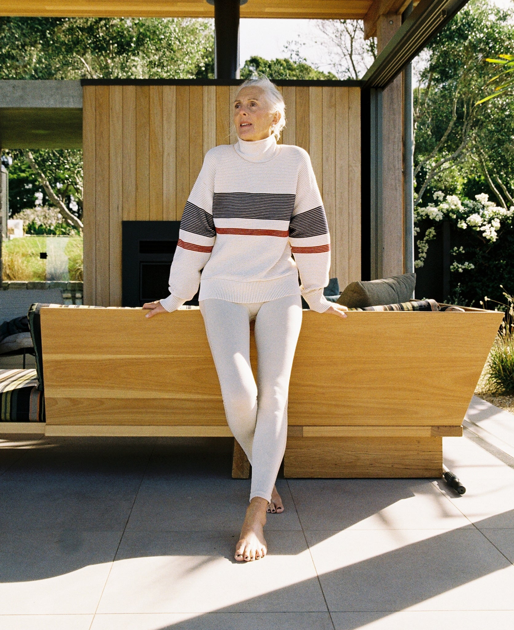 Female model wears the Nagnata Retro Rib Sweater in cream and navy