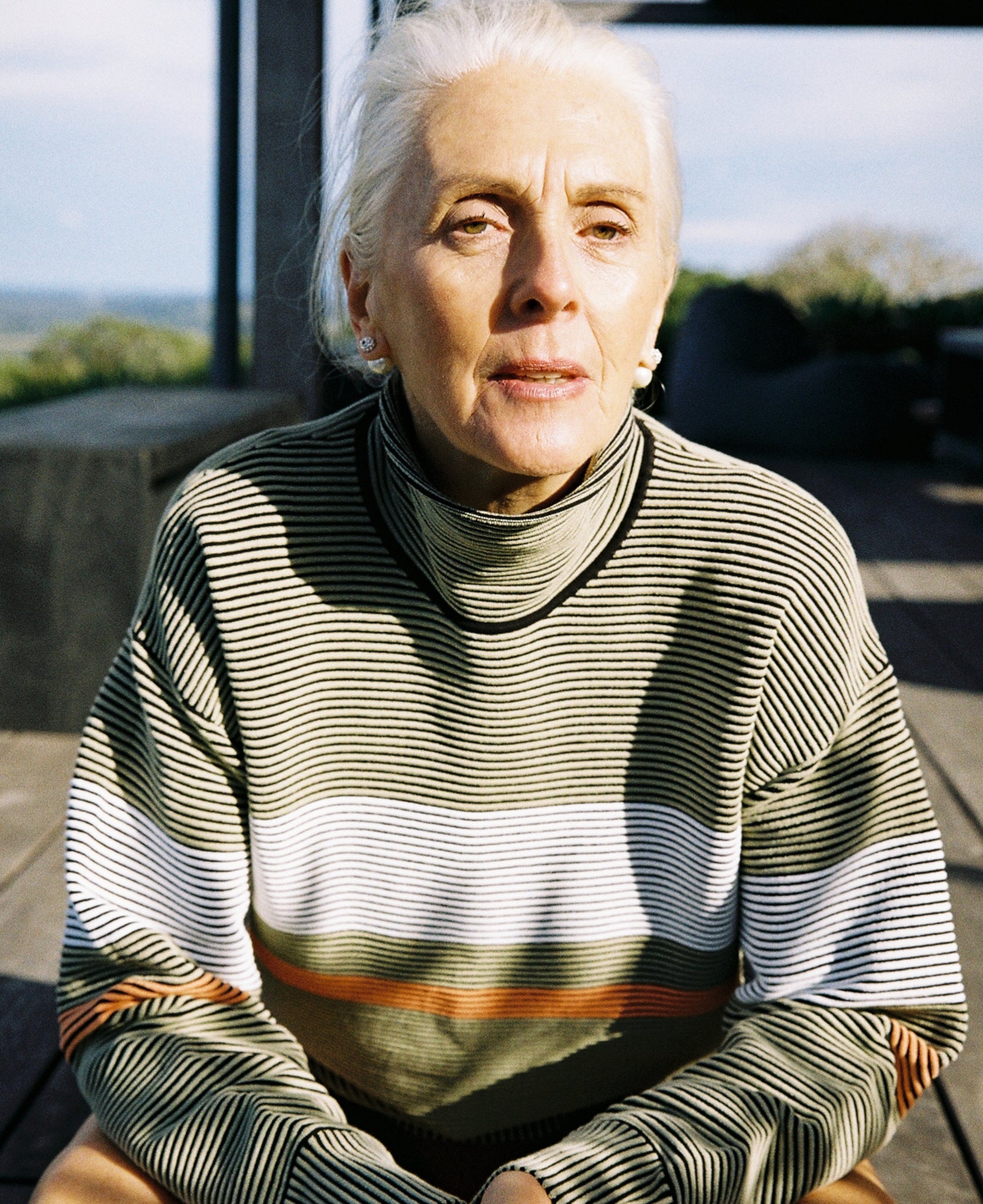 Female model wears the Nagnata Retro Rib Sweater in sage green and cream