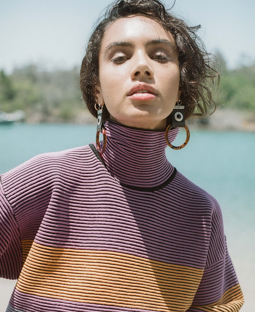 Female model wears the Nagnata Retro Rib Sweater in purple haze and tangerine